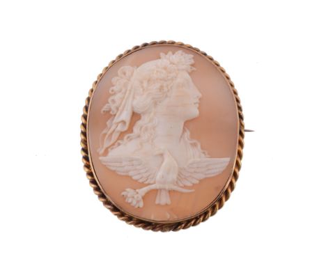  A shell cameo brooch,   the oval cameo carved with the profile of Hemera with flowers in her hair, above an eagle holding a 