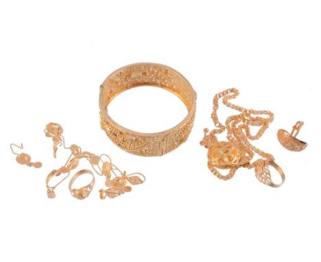  A collection of gold coloured jewellery  , comprising a hinged bangle; six pairs of ear pendents; a necklace with tasselled 