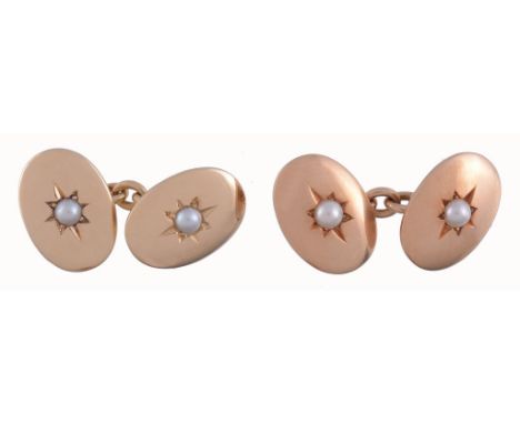  A pair of gold and pearl double sided cufflinks,   the oval panel set with a central pearl in a star shaped setting, with be