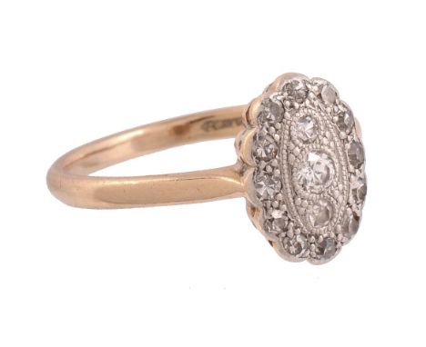  A diamond ring,   the oval shaped panel set with a central brilliant cut diamond within a surround of eight cut diamonds, st