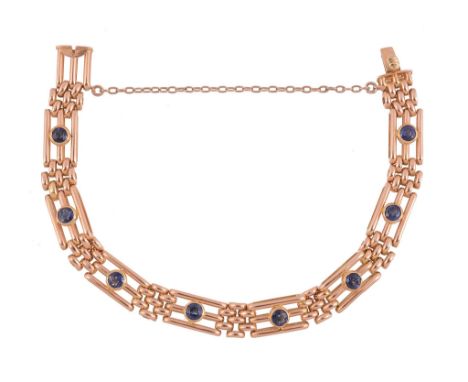  A late Victorian sapphire set gate link bracelet,   circa 1890, the panels each centred with a round cut sapphire in a colle