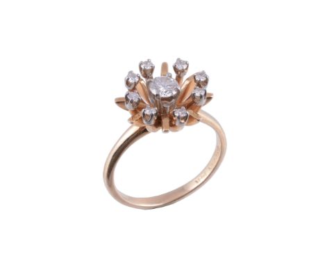  A diamond cluster dress ring by Brogan  , the central diamond, estimated to weigh 0.40 carats, within an open surround of br