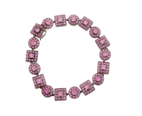  A pink sapphire bracelet,   composed of circular and square shaped panels set throughout with  vari cut pink sapphires, to a