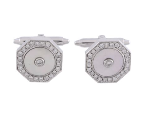  A pair of mother of pearl and diamond cufflinks,   the octagonal mother of pearl panels centrally set with a brilliant cut d
