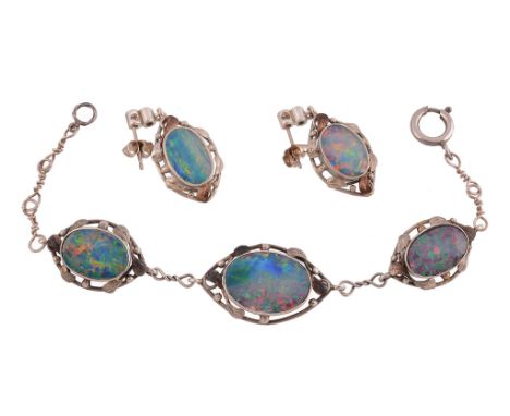  An opal doublet bracelet and ear pendents  , the bracelet with three graduated opal doublets within a beaded foliate surroun