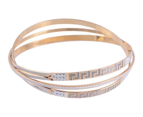  A gold coloured bangle,   the three row bangle with incised decoration, signed Aufinja 22K, 30g  IMPORTANT: This lot is subj