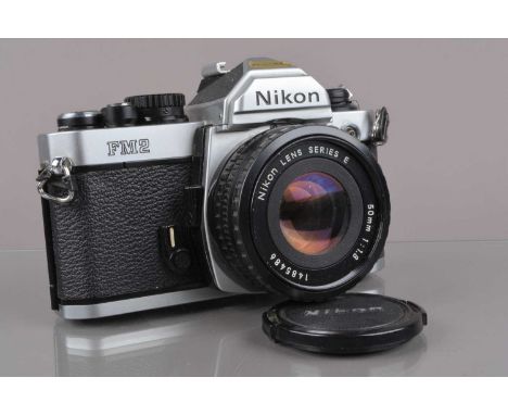 A Nikon FM2 SLR Camera, serial no 7003811, shutter working, meter working, self-timer working, body G some paint wear to back