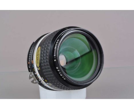 A Nikon Nikkor 35mm f/2 AI-S Lens, serial no 271015, barrel G-VG, elements G-VG, with unbranded rear and Nikon front cap