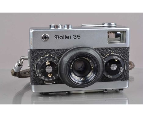 A Rollei 35 Compact Camera,  made in Singapore,  shutter working, winder lever not springing back, meter responsive,  body G-