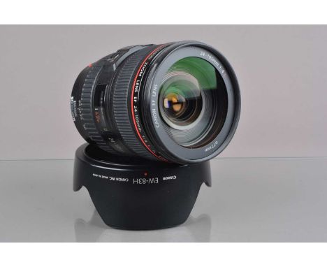 A Canon EF 24-105mm f4 L IS USM Lens,  serial no 640615, auto focus working,  barrel VG, elements VG, with front/rear caps, E