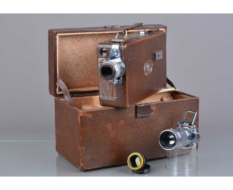 A Cine Kodak Model BB 16mm Cine Camera, brown, motor runs, body G, light wear, with 25mm f/1.9 and 18mm f/4.5 Kodak Anastigma