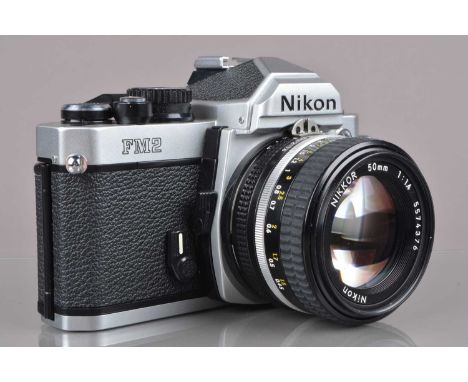 A Nikon FM2n SLR Camera, chrome, serial no 8221993, shutter working, meter responsive, self-timer working, body G, some light