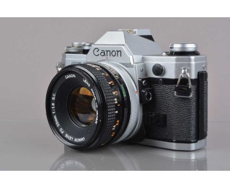 A Canon AE-1 SLR Camera, chrome, serial no 2140973, shutter working, meter working, self-timer working, body G, some light pi