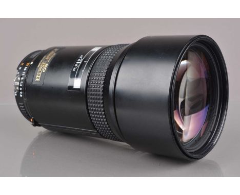 A Nikon ED AF Nikkor 180mm f/2.8 lens, first edition, auto focus working, barrel G-VG, light wear, elements G-VG, with front 