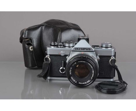 An Olympus OM-1n MD SLR Camera, chrome, serial no 1771231, shutter working, meter responsive, self-timer working, body G, lig