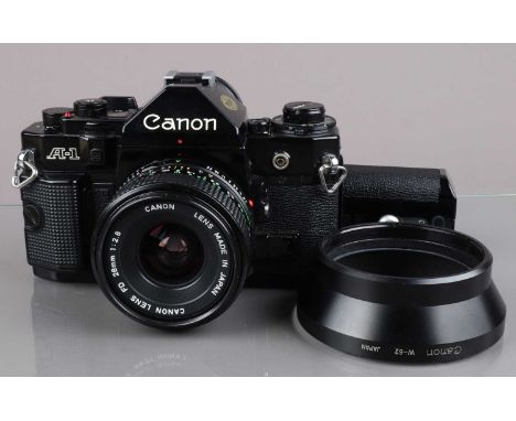 A Canon A-1 SLR Camera, black, serial no 1085447, shutter working, meter working, self-timer working, body G, damage to botto