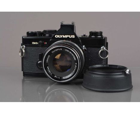 An Olympus OM-2n MD SLR Camera, black, serial no 884784, shutter working, meter responsive, self-timer working, body G, some 