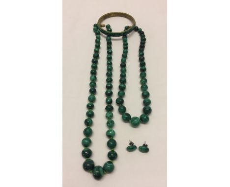 Comprising 2 beaded necklaces, a pair of earrings and a bangle. 