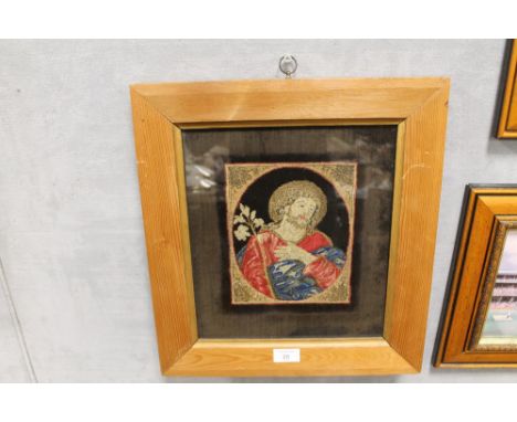 A FRAMED AND GLAZED TAPESTRY PANEL OF JESUS