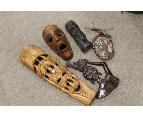 A PAPUA NEW GUINEA CARVED TRIBAL ART SHELL MASK WITH COWRIE SHELLS AND SEEDS, TWO WEST AFRICAN TRIBAL ART MASKS, A CARVED HAR