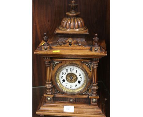 AN ARCHITECTURAL WOODEN CASED 'THE GREENWICH CLOCK' MANTLE CLOCK, ENAMEL DIAL WITH ARABIC NUMERALS WITH CENTRAL FILIGREE PANE