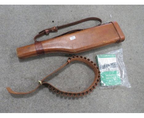 A LEG OF MUTTON LEATHER AND CANVAS SHOTGUN CASE TOGETHER WITH A 12 GAUGE CARTRIDGE LEATHER BELT AND A FIRST EDITION 1960 BOOK