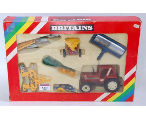 A Britains No. 9591 Fiat tractor and implements set comprising seven various components, all housed in the original labelled 