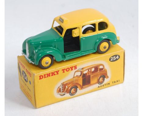 A Dinky Toys No. 254 Austin taxi comprising yellow and green body with yellow hubs in the original incorrect colour spot all-