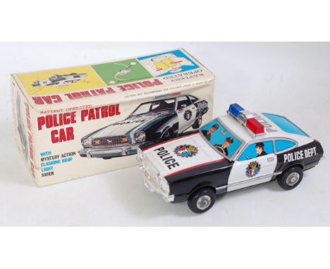 A TN Nomura tinplate plastic and battery operated Police patrol car with mystery action, flashing roof light and siren, in th