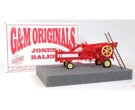 A G&M Originals of Nottingham 1/32 scale white metal and resin model of a Jones Baler, finished in bright red with yellow hub