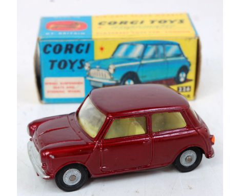 A Corgi Toys No. 226 Morris Mini Minor comprising metallic dark red body with yellow interior and wire worked cast hubs, in t