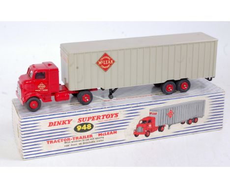 A Dinky Toys No. 948 Mclean Articulated tractor unit and trailer comprising red cab, and body with red hubs and grey trailer,