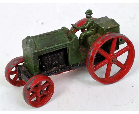 An early Tootsie Toys farm tractor, comprising black, green and red, with driver figure and rear tow-hook (G)