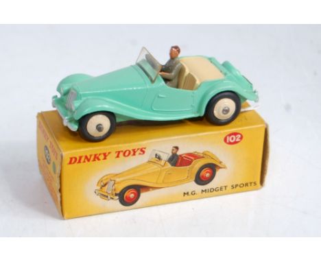 A Dinky Toys No. 102 MG Midget sports car comprising light green body with cream interior and cream hubs and driver figure, i