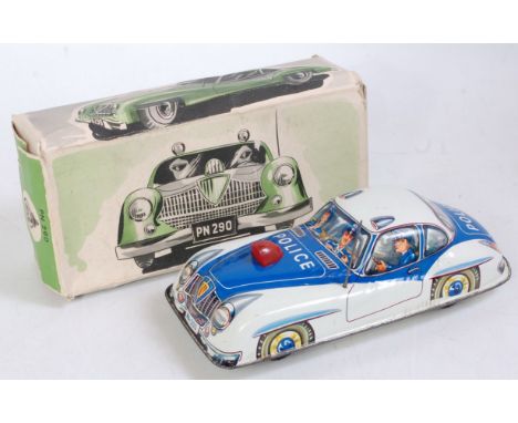 A Philip Niedermeier of Germany tinplate and friction drive model of a Jaguar XK140 Police car comprising cream and blue body