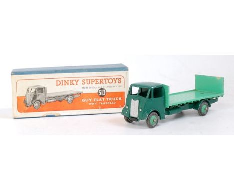 A Dinky Toys No. 513 Guy flat truck with tailboard comprising dark green cab chassis with light green back and hubs, in the o