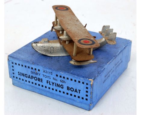 A Dinky Toys No. 60H Singapore Flying Boat comprising silver body with four 2-blade propellers and RAF roundels, some rust to