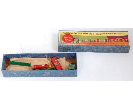 A Hornby Series No.3 railway accessories, comprising tin-printed pillar box, two lighter green seats, green name tape machine