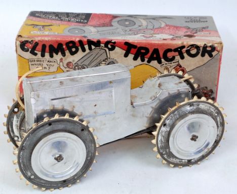 An Animate Toy Company of USA tinplate and clockwork climbing tractor, comprising brushed silver body with matching hubs and 