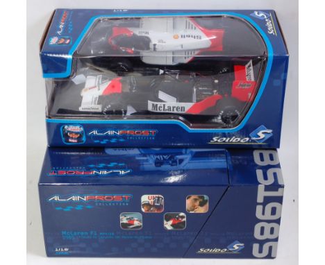 Two boxed Solido 1/18 scale F1 Alain Prost racing diecasts group to include a 1986 Mclaren F1 MP4/2C and a Mclaren F1 MP4/2B 