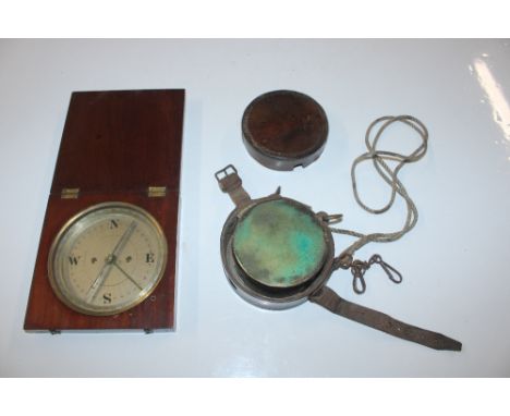 A late Victorian wooden cased compass; and a leather cased night watchman's clock 