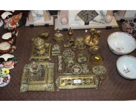 A collection of various brassware to include inkwells, desk stand, horse brasses, chamber stick etc.