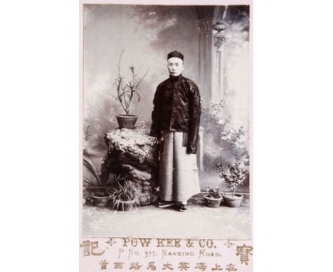 A Chinese black and white photographic portrait of a dignitary in a carved frame, dated 1901 -- Description: Photo: 13,9 x 9,