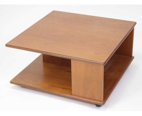 A 1970s G-Plan teak square two-tier coffee table, having open compartments and raised on roller castors, h.40cm, w.79cm, d.79