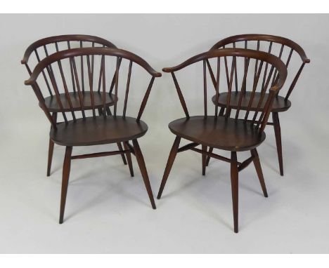 A set of four 1960s Ercol dark elm Model 338 Fireside elbow chairs, each with slightly dished seats on turned supports, w.61.