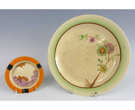 A 1930s Clarice Cliff pottery circular ashtray, with bright orange painted border and three cigarette rests, black printed ba