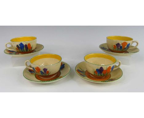 A set of four 1930s Clarice Cliff Crocus pattern pottery teacups and saucers, each with typical painted decoration and black 