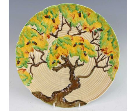 An Art Deco Carltonware Acorn Tree pattern pottery charger, of ribbed and moulded form, bright colour stylised decoration, pr