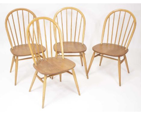 A set of four Ercol model 370 light elm stickback dining chairs, on typical plain turned and slightly tapering supports, labe