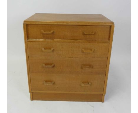 Ernest Gomme for G-Plan - a 1960s light oak chest of four long graduated drawers, with curved handles, h.84.5cm, w.76cm, d.45